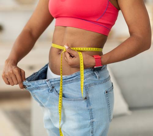 woman-after-weight-loss-measuring-waist-wearing-ov-8ANHBTR(1) Natural Medicine